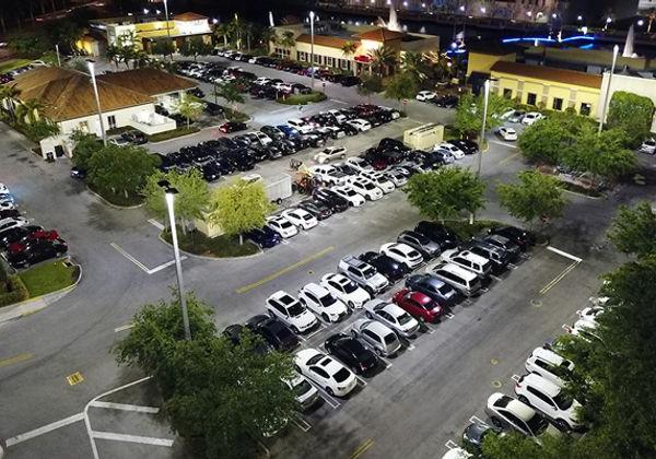 An aerial view of the outdoor LED lighting at The Palms Town 国家 building 和 parking lot at night